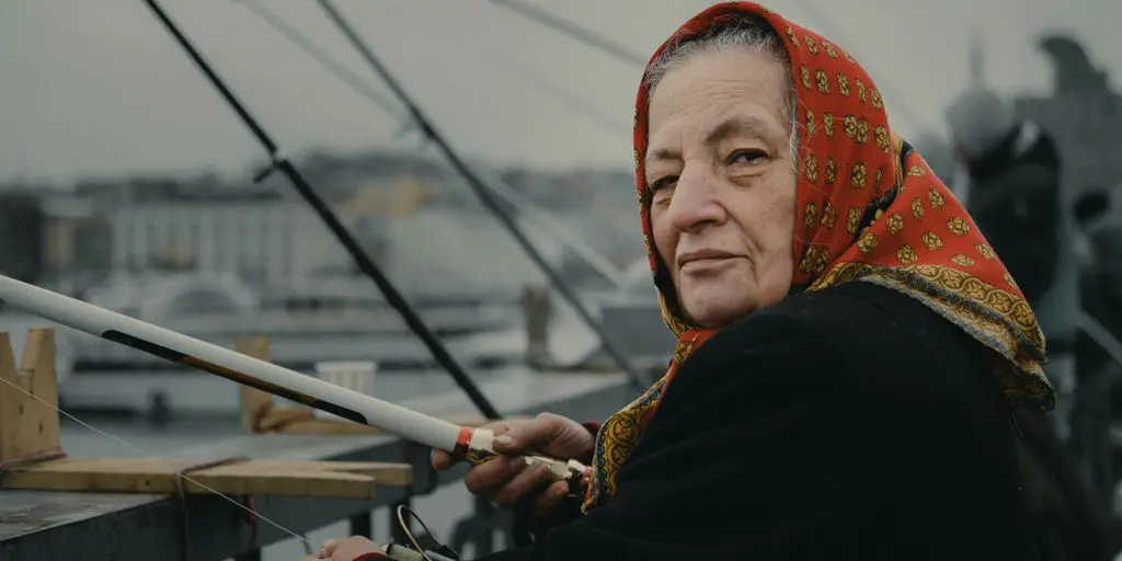 woman fishing on bridge during daytime