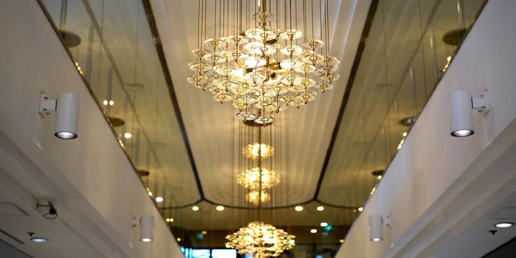 gold and white chandelier turned on in a room